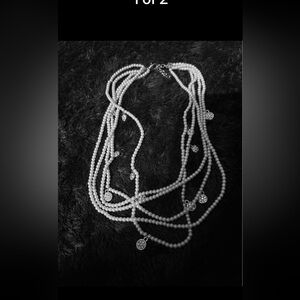 Fun multi-strand pearl necklace with silver and faux diamond accents.